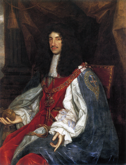 Seated man of thin build with chest-length curly black hair