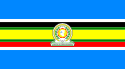 Nine horizontal strips colored (from top to bottom): blue, white, black, green, yellow, green, red, white, then blue. The logo of the EAC is placed in the center.